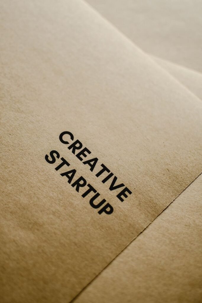 A close-up image of black text 'Creative Startup' on brown paper, highlighting entrepreneurship and innovation.
